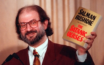 SALMAN RUSHDIE...Novelist Salman Rushdie holds paperback copy of his controversial novel."The Satanic Verses" March 4, 1992 during a speech in Arlington, Va.. He spoke at an international conference on free expression sponsored by the Freedom Forum and American University. (AP Photo/Ron Edmonds)


