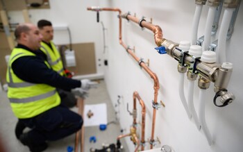 SLOUGH, ENGLAND - NOVEMBER 02: Plumbing engineers install the pipework for a heat pump system at the Octopus Energy training facility on November 02, 2021 in Slough, England. Ahead of COP26, the UK government announced plans to offer grants to help households install air-source heat pumps over the next three years, encouraging them to ditch their gas and oil-fired boilers. (Photo by Leon Neal/Getty Images)