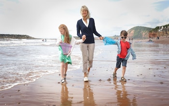 Jane Corry with her grandchildren Milly and George on the beach in Sidmouth