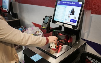A supermarket customer using the self-checkout till
