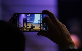 An Audience members records a conversation using their mobile phone