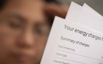 a householder looking at an energy bill