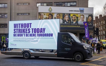 A van carrying a Unison poster passes Waterloo Ambulance Station in London as personnel from nine NHS hospital trusts in Britain and Wales strike