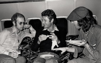 Tony King, centre, with Elton John and John Lennon on a flight to Boston in 1974 