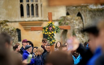 Pilgrims carry their cross through Walsingham on the final leg of their easter pilgrimage 