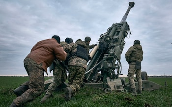 Ukrainian soldiers prepare a U.S.-supplied M777 howitzer to fire at Russian positions in Kherson region