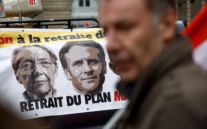 A banner depicting French Prime Minister Elisabeth Borne and French President Emmanuel Macron is pictured as protestors attend a demonstration against pension reform in Rennes on the day the French government unveils its pension reform, France, January 10, 2023. REUTERS/Stephane Mahe