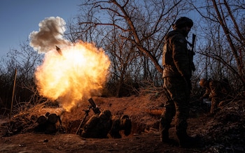 Ukrainian servicemen fire a 120 mm mortar towards Russian positions at the frontline near Bakhmut