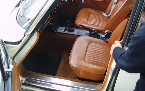 'The interior, with its four leather-upholstered bucket seats, was akin to a mobile office'