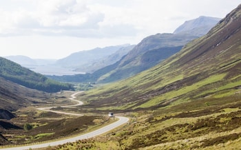 A bus driving the road to Torridon in Scottish Highlands