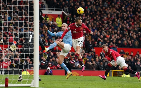 Manchester United's Luke Shaw clears with a defensive header under pressure from Manchester City's Erling Haaland during the Premier League match - Pep Guardiola: We need to get more out of Erling Haaland