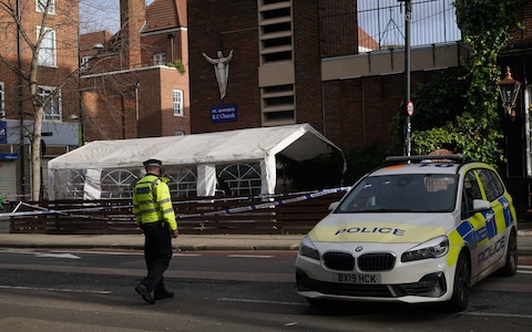 Police at the scene of the shooting outside the memorial service