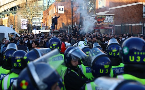 General view of fans and police outside the stadium before the match