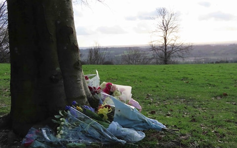 Dog walkers and local residents leave flowers at the scene of the attack