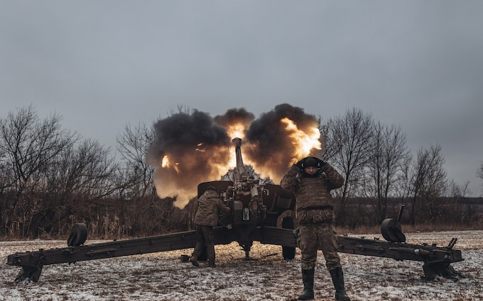 Ukrainian soldiers work in their artillery unit in the direction of Marinka